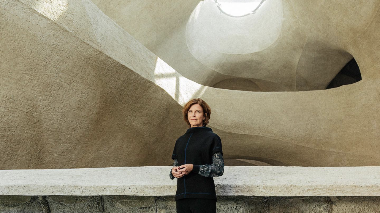 Woman standing in front of stone