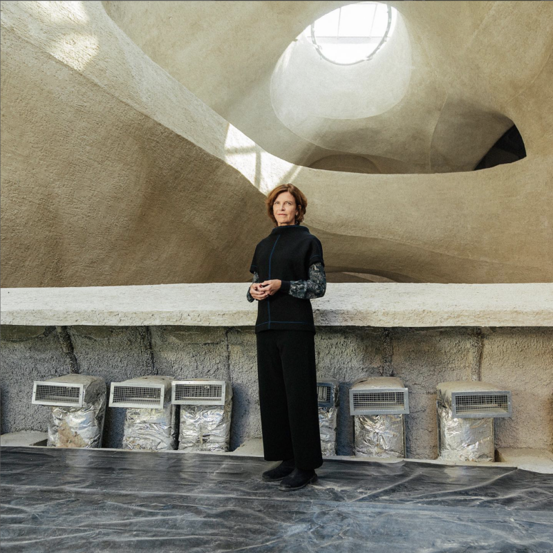 Woman standing in front of stone